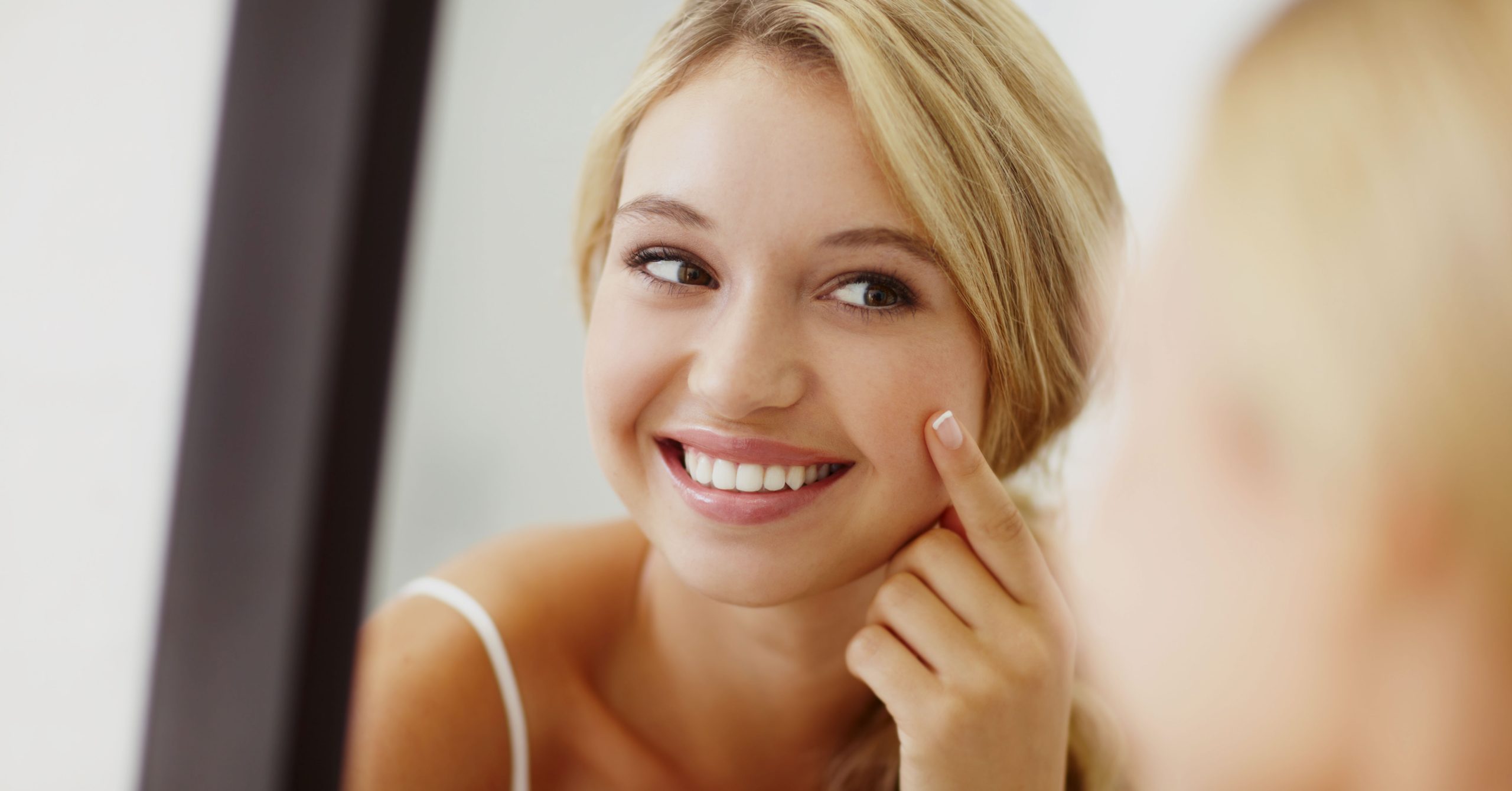 a young girl who is smiling and looking at the camera